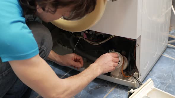 Man Fixes Washing Machine Repairs Broken Destroyed alt