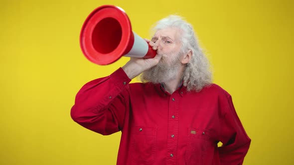 Cheerful Senior Greyhaired Man Imitating Speaking in Megaphone Using Road Cone alt