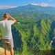 Man Standing on top of a mountain looking at beautiful mountains view in Ella, Sri Lanka - VideoHive Item for Sale
