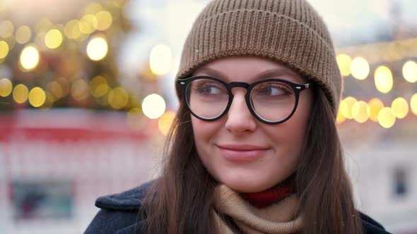 Pretty Woman Stands on the City Square Among Christmas Decorations alt