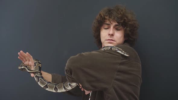 a Person is a Little Afraid of a Snake That Crawls on His Hands He is Confused and Can Not Move