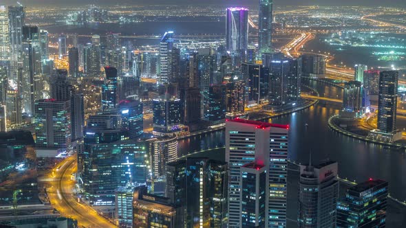 Panoramic Aerial View of Business Bay Towers in Dubai Night Timelapse alt