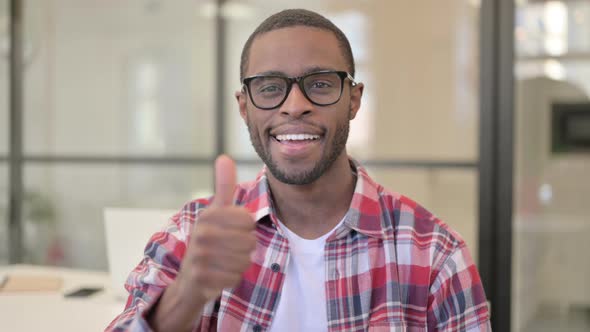 Portrait of African Man Showing Thumbs Up Sign alt