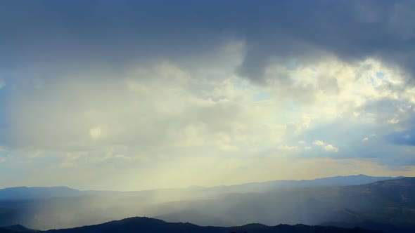 Beautiful morning nature, sunlight gaps in thick fog over mountains, heaven alt