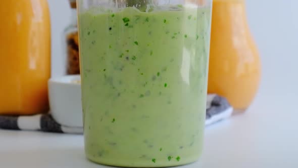 Slow Motion Woman Cooking Healthy Smoothie Add Green Apple Kiwi Spinach Blended in Blender Green alt
