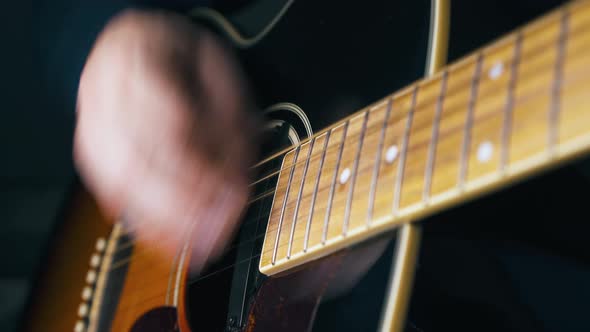 Delighted Person Plays Acoustic Guitar with Hand Closeup alt