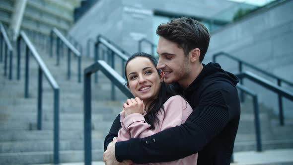 Embracing Couple Talking in Slow Motion. Joyful Man Making Laugh of Woman alt