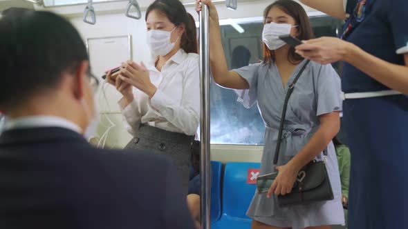 Crowd of People Wearing Face Mask on a Crowded Public Subway Train Travel alt