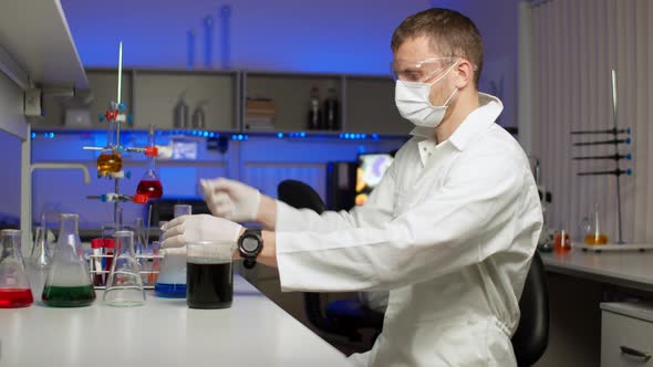 Young Scientist Blending Colored Liquid