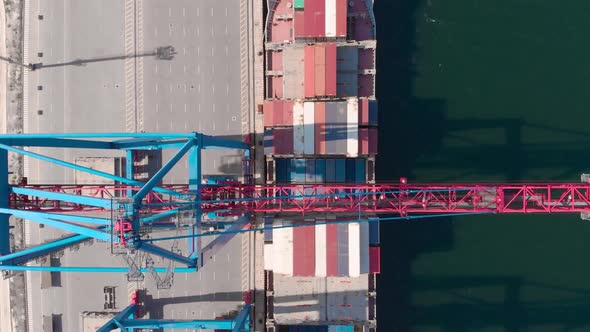 Drone Flying Over a Container Ship During Cargo Operations Over the Customs Area alt