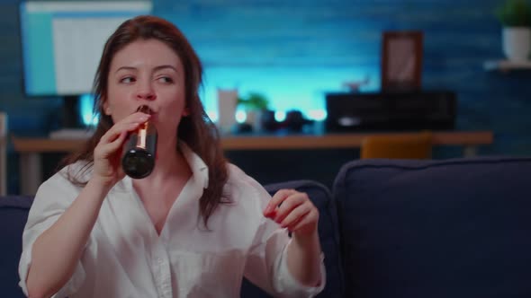 Caucasian Woman Eating Burger and Cheering at Sport Game alt