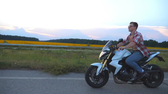 Young Man Riding on a Modern Sport Motorbike alt