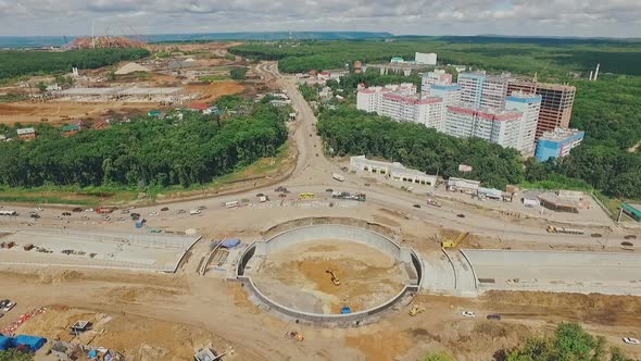 Drone Is Flying To Construction of Traffic Circle in Sunny Summer Day, From Long Shot To Details