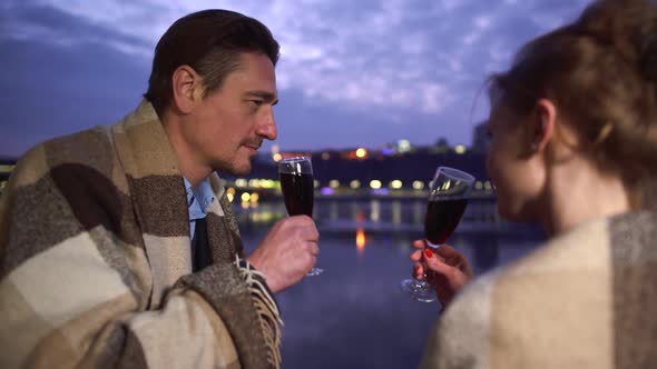 Man and Woman Drink Alcohol From Wine Glasses Close Up. Couple Clink Glasses Wine Glasses alt