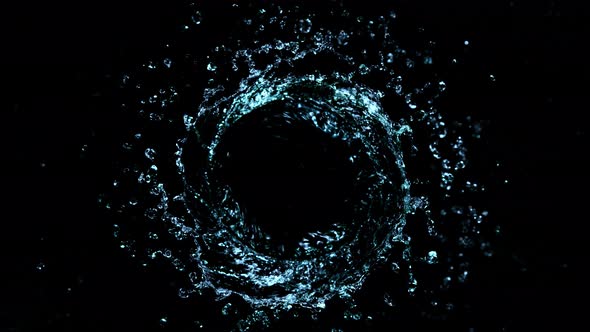 Super Slow Motion Shot of Rotating Water Splash Isolated on Black Background at 1000Fps. alt