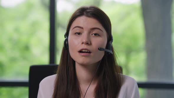 Smiling Beautiful Caucasian Woman in Earphones Talking Looking at Camera in Video Chat alt