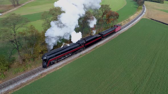 Aerial View of an Antique Restored Steam Locomotive Traveling Thru Countryside