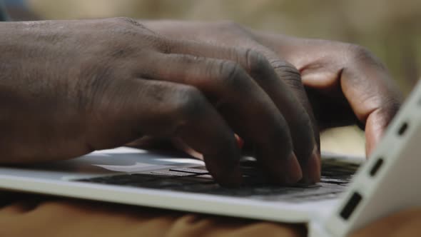 Close Up, Hands of an African Man Using Laptop alt