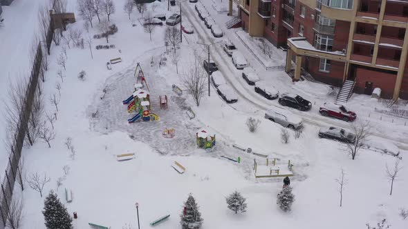 A Snow Blower Removes Snow on the Playground with the Help of Special Equipment in the Courtyard of