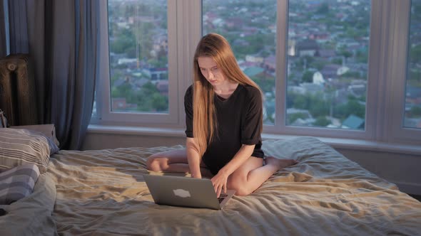 Young Girl Woman on the Bed Distance Learning for Students