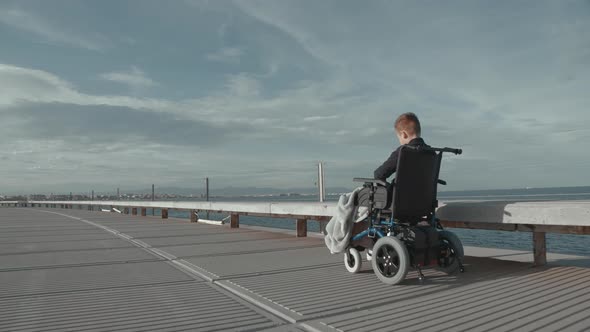 Outdoor ride of disabled child in electric wheelchair