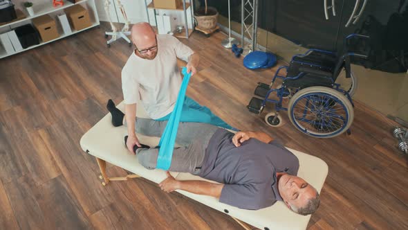 A Professional Physiotherapist Conducts Rehabilitation of a Patient alt