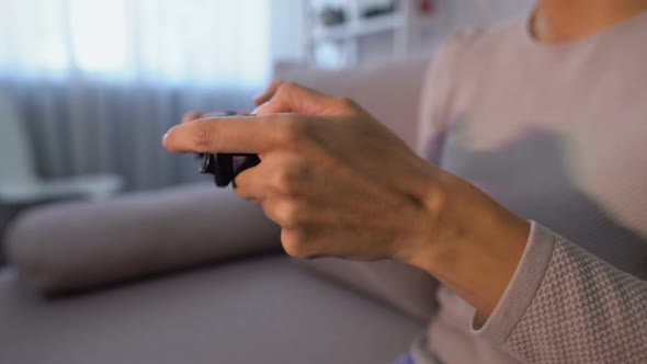 Dissatisfied Female Playing Video Game on Console, Pushing Joystick Buttons