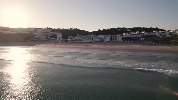 Gorgeous sunbeam reflection on calm sea waters, Salema beach, Algarve. Aerial view alt