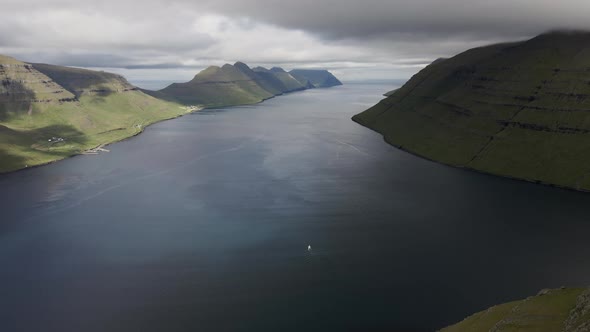 Drone Over Hikers On Klakkur Mountain Summit With Sea Beyond alt