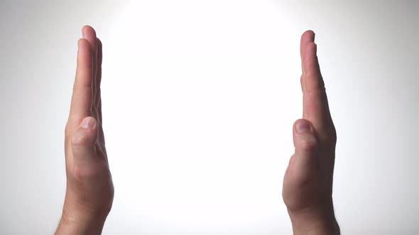 Men's Hand Palm Gesture Move Towards Each Other to Show the Distance Volume