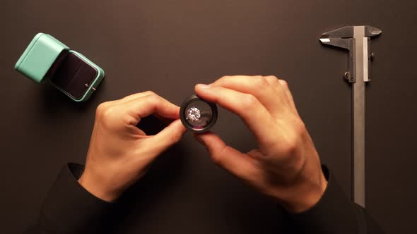Male Jeweler Examining Diamond Ring