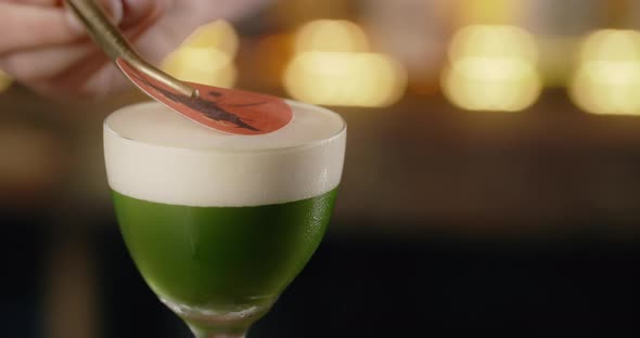 Barman Finalizes the Cocktail with Sugar Print in Slow Motion Bartender Makes Cocktail on the Bar alt