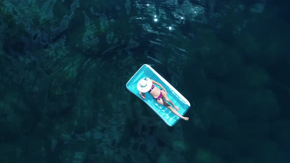 Woman Lying On Air Mattress alt