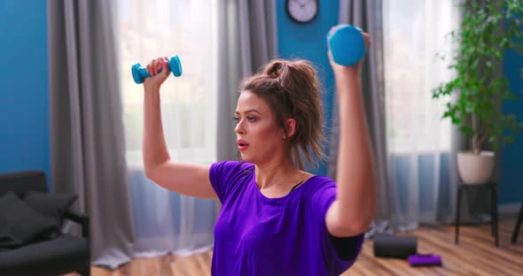 Determined Woman Losing Weight at Home and Exercising with Dumbbells alt