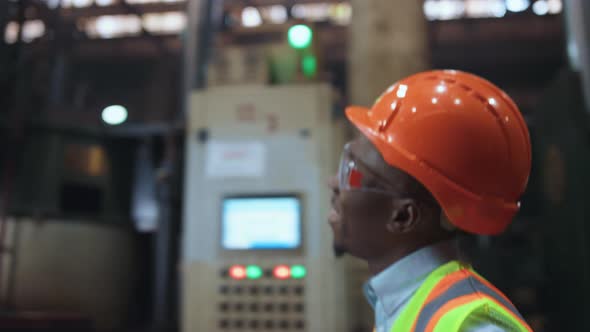 Joyful Man Engineer Smiling at Huge Modern Factory Wearing Safety Uniform alt