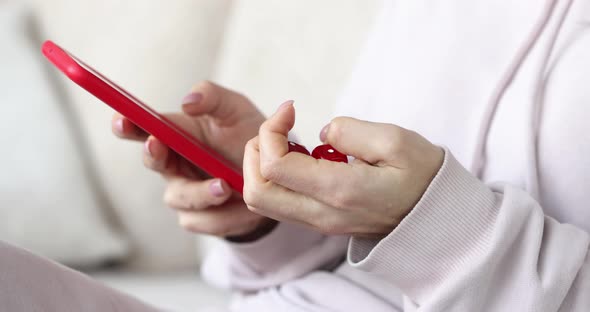 Person Holds Smartphone and Sorts Through Dice alt