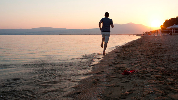 Man Running Along A Beach At Sunset, Stock Footage VideoHive
