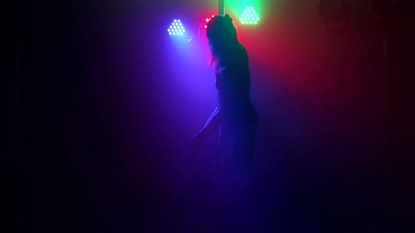 Silhouette of Girl Performing Erotic Dance in Dark alt