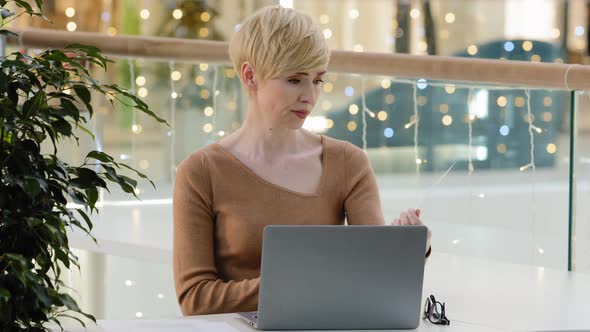 Caucasian Middle Aged Business Woman Teacher Freelancer Paperwork Sitting Table with Laptop alt