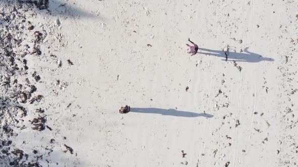 Vertical Video People Play Football on the Beach in Zanzibar Tanzania Aerial View alt