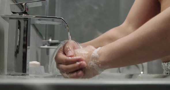 Slow Motion Closeup of Man Washing His Hands With Soap