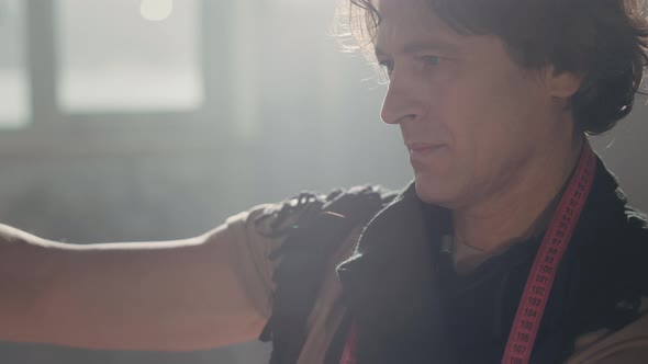 Designer Working On Creating Clothes In Workshop alt