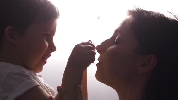 Mother and Son in White T-shirts on a White Background alt