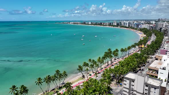 Aerial panning shot of turquoise water beach at Maceio Alagoas Brazil. alt