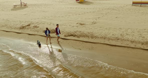 Aerial View a Guy and a Girl Walking Along the Riverbank Bare Feet Walking on the Water alt