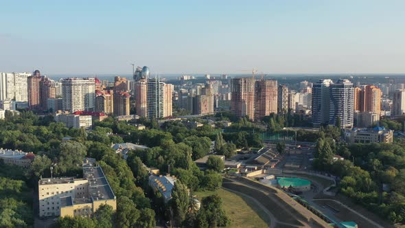 Aerial drone video of downtown skyline buildings in Kyiv Ukraine during sunset. Overlooking Olympiys alt