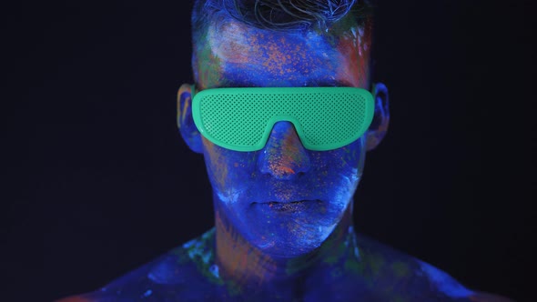 Closeup of a Man with Drawings on His Body Take Off Green Glowing Disco Glasses alt