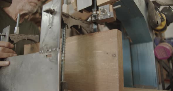 Woodworker pushes a saw metal plate