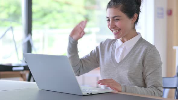 Indian Woman Doing Video Chat on Laptop at Work  alt