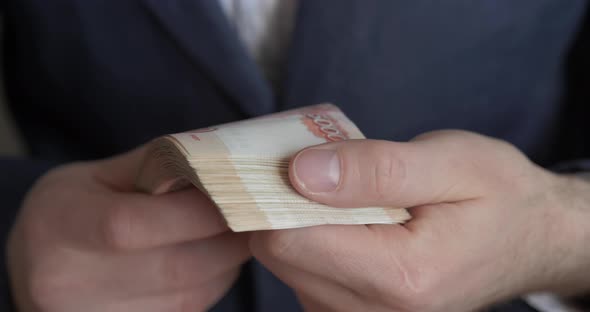 Male Hands Counting Money. Russian Money Banknotes of 5,000 Rubles